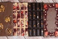 Different kinds fof chocolate bars laying in a row on vintage wooden background.