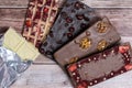 Different kinds fof chocolate bars on vintage wooden background.