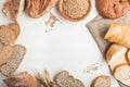Different kinds of fresh baked bread in a form of frame on a white wooden background. top view, copy space Royalty Free Stock Photo