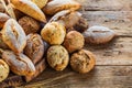 Different kinds of fresh bread on wooden table. assortment of bread on brown background Royalty Free Stock Photo