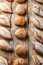 Different kinds of fresh bread on wooden table. Isolated assortment of bread on brown background Royalty Free Stock Photo