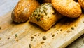 Different kinds of fresh bread on wooden table. Isolated assortment of bread on brown background. Slider shooting Royalty Free Stock Photo