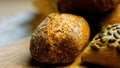 Different kinds of fresh bread on wooden table. Isolated assortment of bread on brown background. Slider shooting Royalty Free Stock Photo