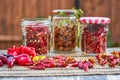 Different kinds of fresh and dried red and yellow hot chilli peppers. Royalty Free Stock Photo