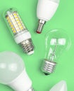 Different kinds of light bulbs together, eco green background. Energy saving concept. Flat lay, top view photo Royalty Free Stock Photo