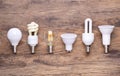 Different kinds of light bulbs on wooden background Royalty Free Stock Photo