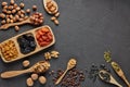 Different kinds of nuts, dried fruits on black slate background. Top view with copy space. Healthy food. Vegetarian nutrition Royalty Free Stock Photo