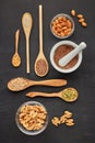 Different kinds of nuts and seeds on black slate background. Top view. Healthy food. Vegetarian nutrition Royalty Free Stock Photo