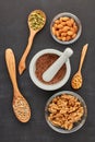 Different kinds of nuts and seeds on black slate background. Top view. Healthy food. Vegetarian nutrition Royalty Free Stock Photo