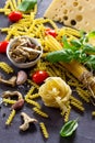 Different kinds of pasta with ingredients mushrooms, basil, cherry tomato, garlic, pepper, cheese Royalty Free Stock Photo