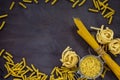 Different kinds of pasta on the kitchen wooden table. The concept of Italian food.