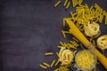 Different kinds of pasta on the kitchen wooden table. The concept of Italian food.