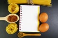 Different kinds of pasta tagliatelle, spaghetti, italian foods concept and menu design, spices on wooden spoons, raw eggs on a sha