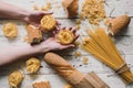 Different kinds of pasta on wooden table, bread