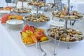 Various pastries and fruits displayed on silver trays