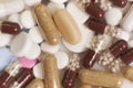 Different kinds pills falling on white background in slow motion. Multi-colored tablets are flying. Beautiful drop pills Royalty Free Stock Photo