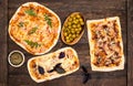 Different kinds of small pizza on rustic wooden background. Various homemade pizza, dinner party at home, top view