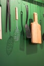 Different kitchen tools for cooking hanging on the wall. Royalty Free Stock Photo