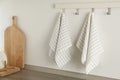 Different kitchen towels hanging on hook rack