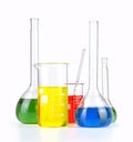 Different laboratory glassware with colored liquid isolated over white Royalty Free Stock Photo