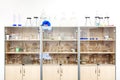 Different laboratory glassware and equipment on shelves