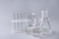 Different laboratory glassware on grey background Royalty Free Stock Photo