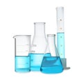 Different laboratory glassware with light blue liquid isolated on white Royalty Free Stock Photo