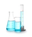 Different laboratory glassware with light blue liquid isolated on white Royalty Free Stock Photo