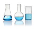 Different laboratory glassware with blue liquid isolated on white Royalty Free Stock Photo