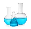 Different laboratory glassware with blue liquid on white background Royalty Free Stock Photo