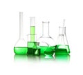 Different laboratory glassware with green liquid isolated on white Royalty Free Stock Photo
