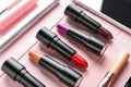 Different lipsticks on color table Royalty Free Stock Photo