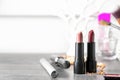 Different lipsticks and other cosmetics on grey table Royalty Free Stock Photo