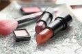 Different lipsticks and other cosmetics on table Royalty Free Stock Photo