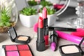 Different lipsticks and other cosmetics on table Royalty Free Stock Photo