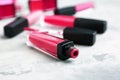 Different liquid lipsticks on grey table Royalty Free Stock Photo