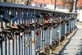 Different love locks attached to the metal grid of a bridge in E Royalty Free Stock Photo