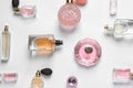 Different luxury perfume bottles on white background