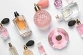 Different luxury perfume bottles on white background