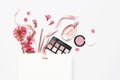 Different makeup cosmetic. Ball blush rouge lipstick concealer bottle of perfume makeup brush spring pink flowers in