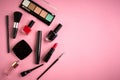 Different makeup products composition on pink background