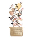 Different makeup products falling into beauty bag on white background. Decorative cosmetics Royalty Free Stock Photo