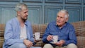 Different male generations family of senior father and adult son or grandson relaxing, drinking tea Royalty Free Stock Photo