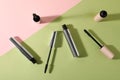 Different mascaras on color background, flat lay