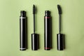 Different mascaras for eyelashes on light background, flat lay. Makeup product