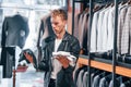 Different material types. Young guy in modern store with new clothes. Elegant expensive wear for men Royalty Free Stock Photo