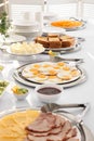 Different meals for breakfast on white table indoors. Buffet service Royalty Free Stock Photo