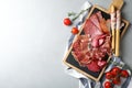 Different meat delicacies served on gray table, top view Royalty Free Stock Photo