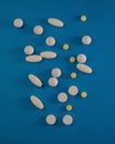 Different medical pills lie on a blue background