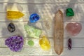 Different minerals and crystals on the white wooden background